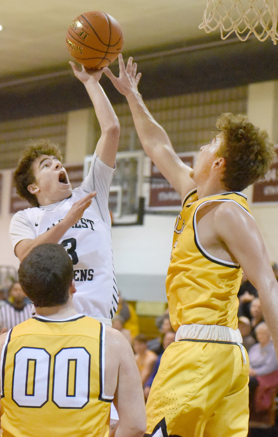 Noah Miller gets a shot off for Hillcrest Academy over the outstretched hand of Lone Tree’s Keegan Edwards.